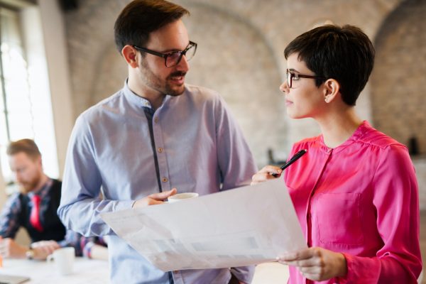 Portrait of two architects looking at project scheme